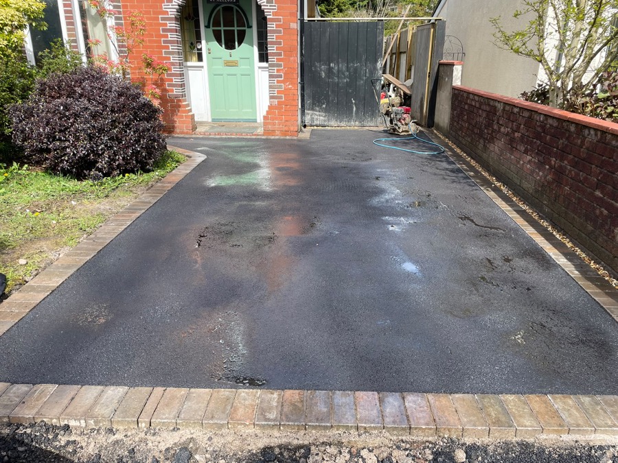 Freshly laid tarmac driveway with block paved border