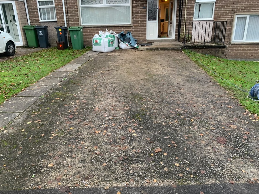 Old moss-covered concrete driveway before work
