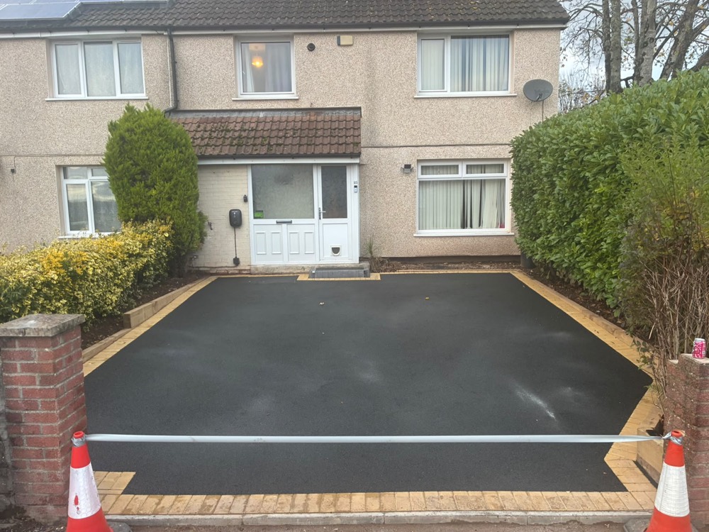 Freshly surfaced tarmac driveway with block paved edging